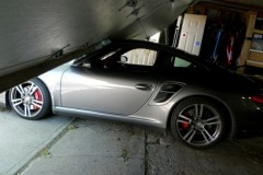 car_crash_son_launches_porsche_turbo_press_car_through_garage_door_01